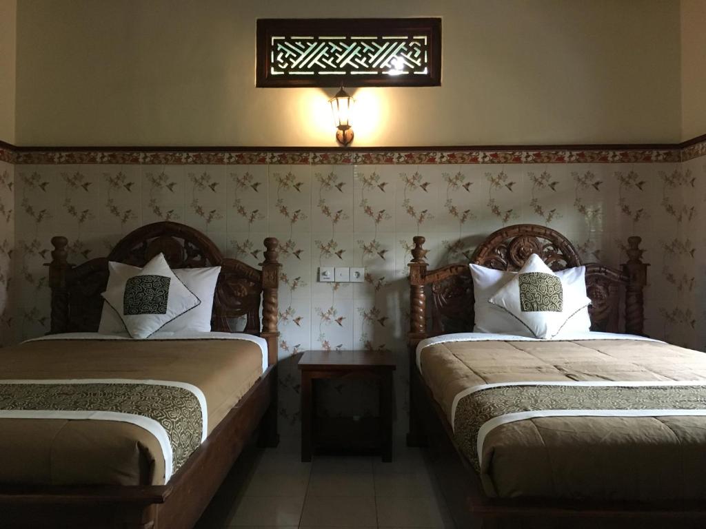 Postel nebo postele na pokoji v ubytování Eka's Homestay