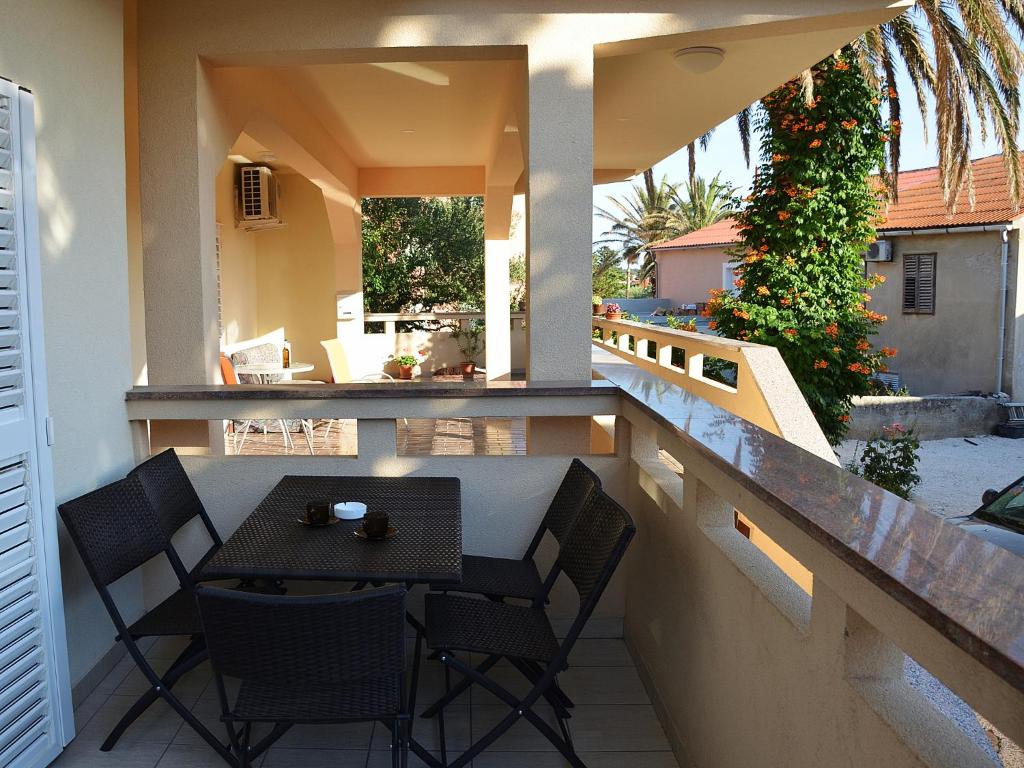 a patio with a table and chairs on a balcony at Apartment Summer Paradise in Novalja