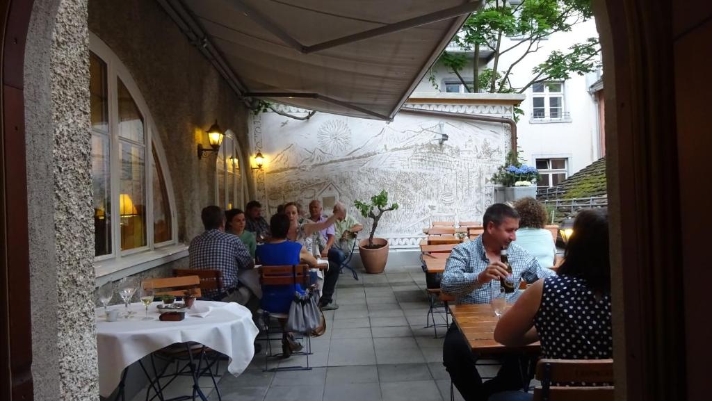 a group of people sitting at tables in a restaurant at Zunfthaus zur Rebleuten in Chur