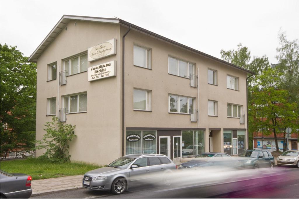 a building with cars parked in front of it at Gasthaus Kantolankulma in Lappeenranta