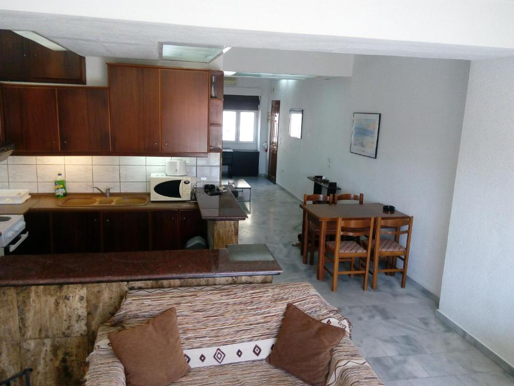 a kitchen with a couch and a table in a room at Live your myth in Kavala in Kavála