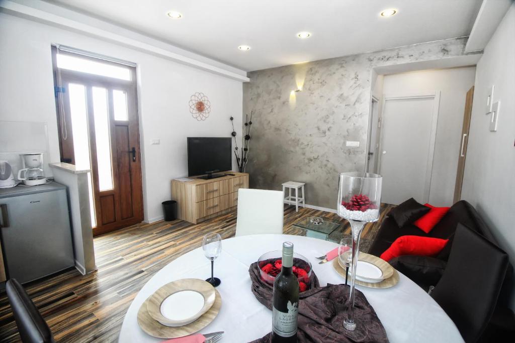 a living room with a white table and a living room at Apartments and Rooms Lorena 236 in Rovinj