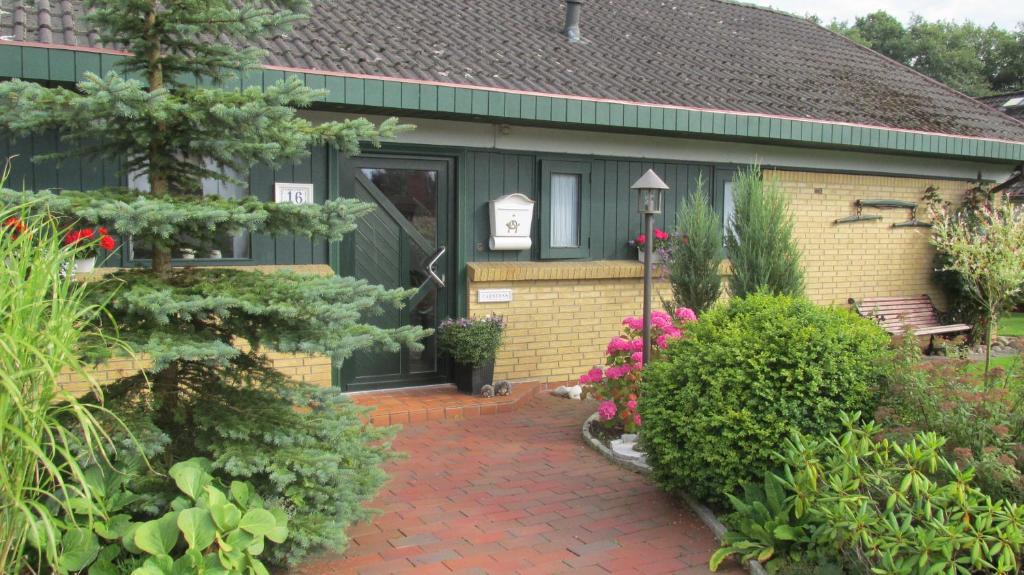 a house with a brick walkway leading to the front door at Gästehaus Carstens in Friedrichstadt