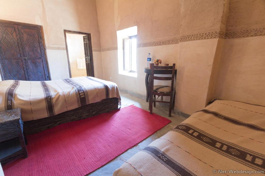 Postel nebo postele na pokoji v ubytování Kasbah Imdoukal
