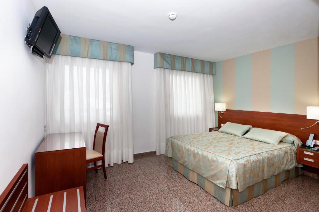 Postel nebo postele na pokoji v ubytování Hotel Marivella