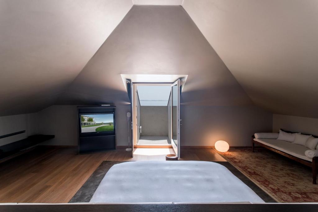 Postel nebo postele na pokoji v ubytování Hotel Bella Riva