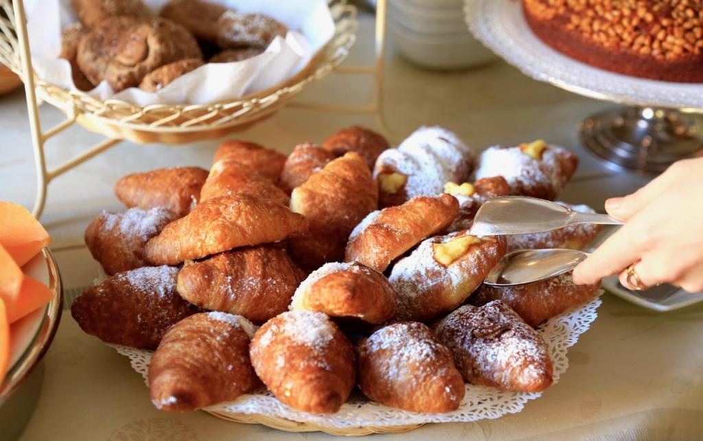 a plate of donuts and other pastries on a table at Villa Agnese in Sestri Levante