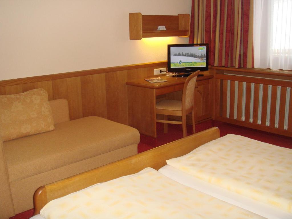 Postel nebo postele na pokoji v ubytování Hotel Sporthof