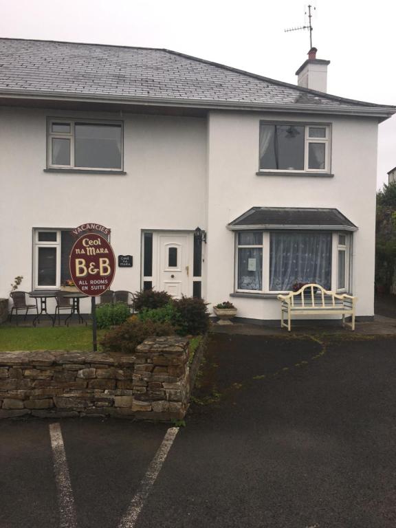 a white house with a sign in front of it at Ceol Na Mara in Westport