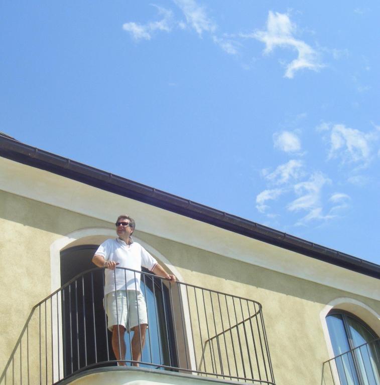 a man standing on a balcony of a building at Villa Agnese in Sestri Levante