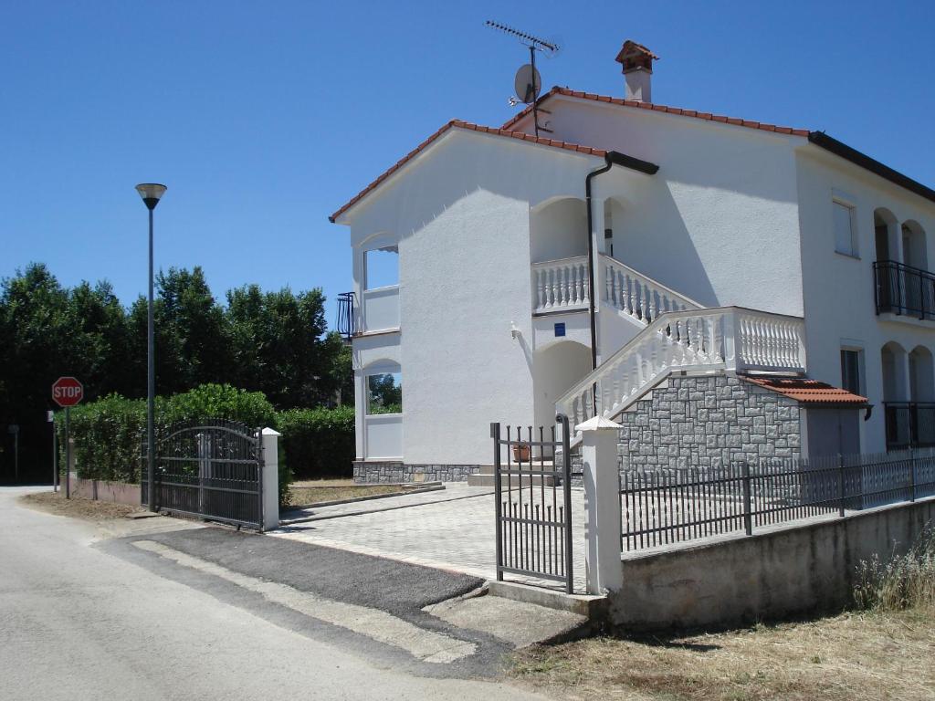 a white building with a staircase in front of it at Guesthouse Pejo in Poreč