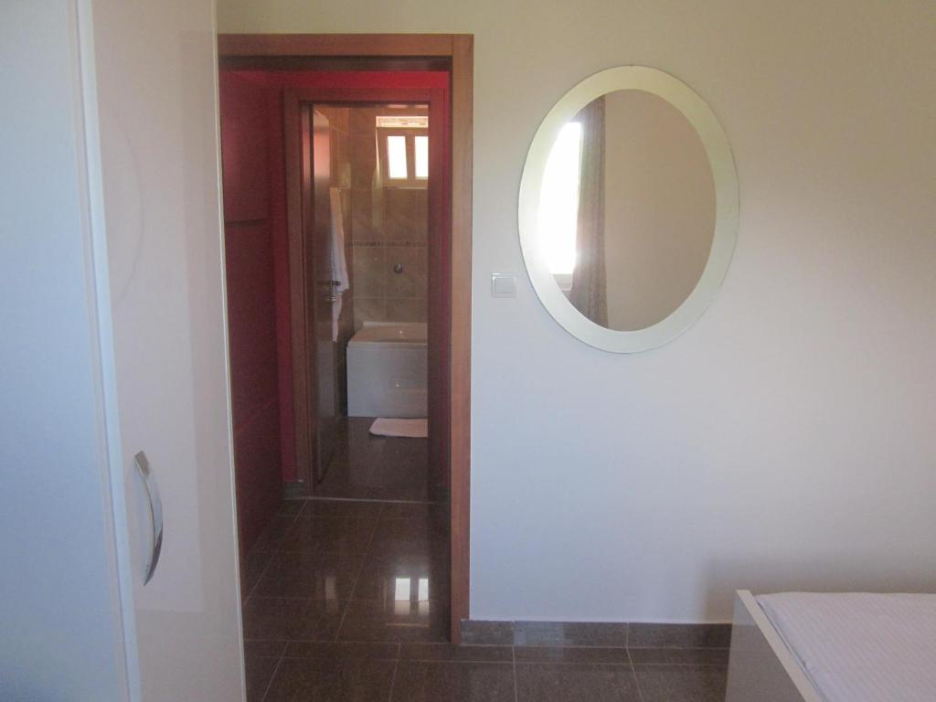 a bathroom with a mirror and a sink at Apartments Danilo Kažanegra in Sveti Stefan