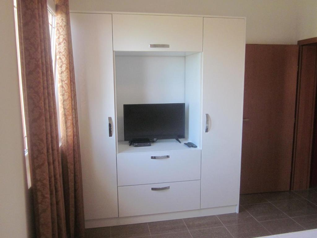 a white cabinet with a television in it at Apartments Danilo Kažanegra in Sveti Stefan