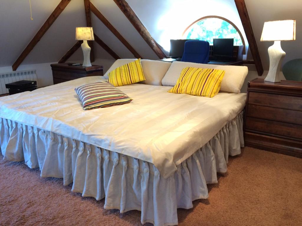 a bedroom with a large bed with yellow pillows at Paivilla Boutique Hotel in Tallinn