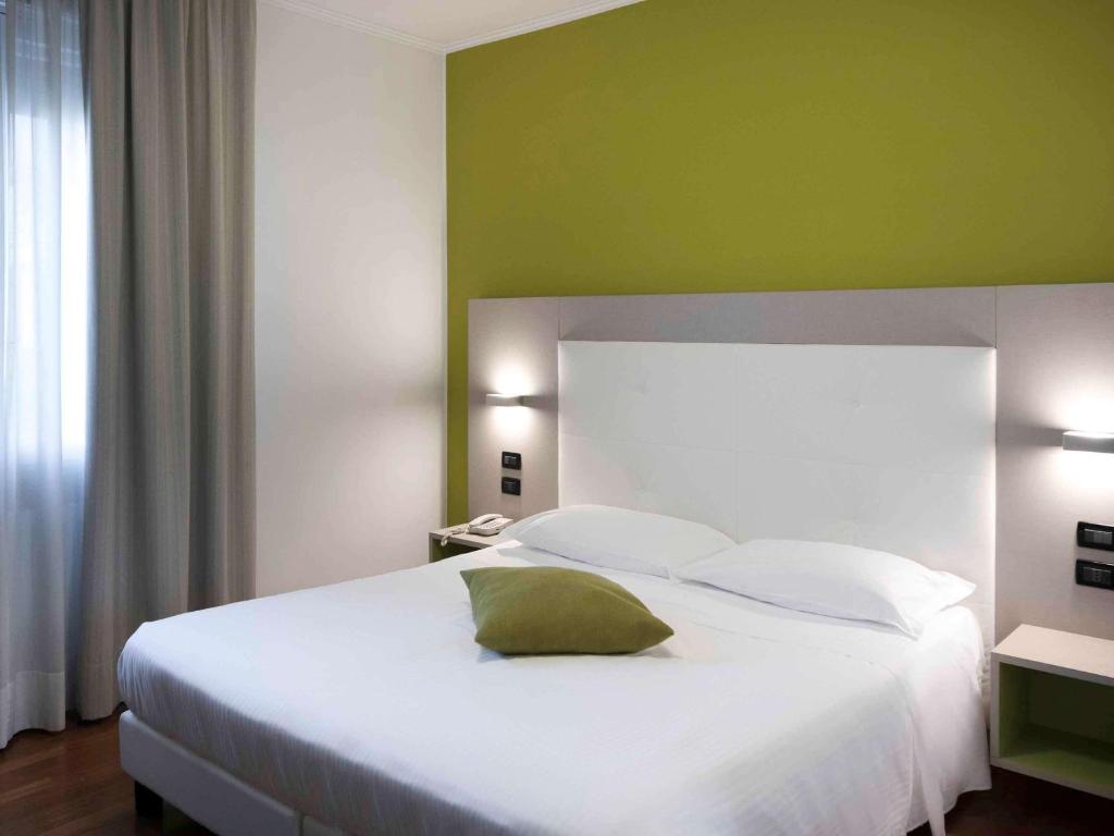 Postel nebo postele na pokoji v ubytování Hotel Milano Palmanova