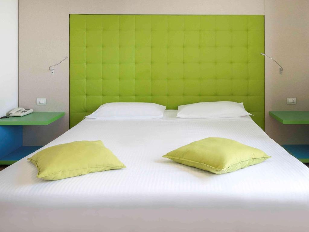 Postel nebo postele na pokoji v ubytování Hotel Milano Palmanova