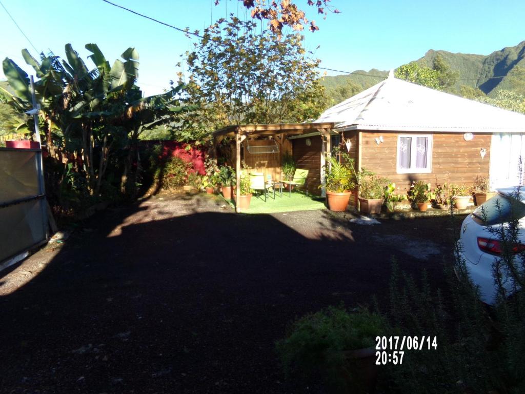 a view of a house with a yard at Les Aubepines in La Plaine des Palmistes