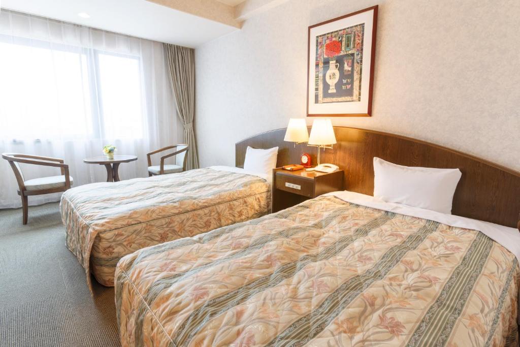Postel nebo postele na pokoji v ubytování Hotel Amabile Maizuru