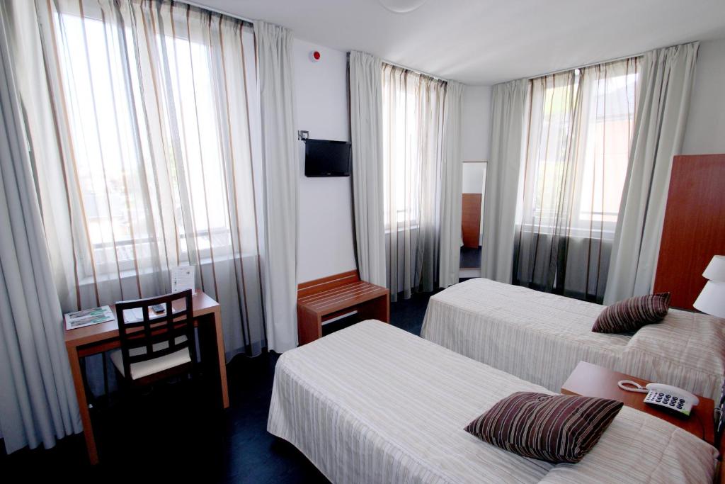 Postel nebo postele na pokoji v ubytování Hotel Florence