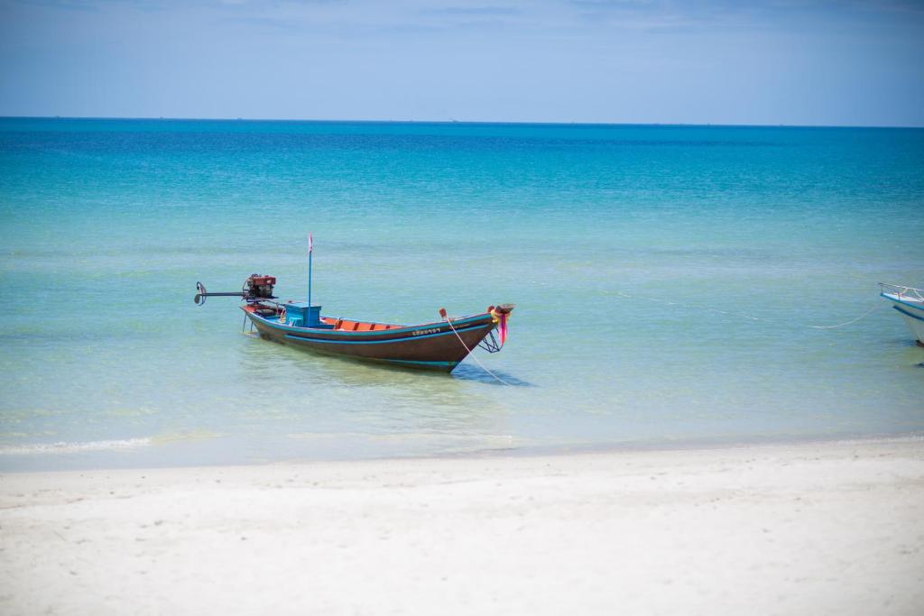 a boat sitting in the water on the beach at Bottle Beach 1 Resort in Bottle Beach