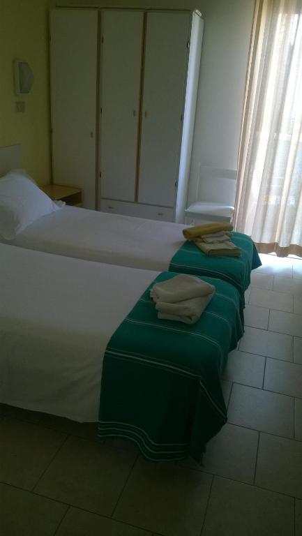 Postel nebo postele na pokoji v ubytování Albergo Maria Gabriella