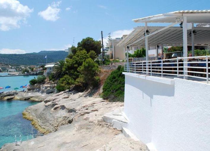 a balcony of a house next to a body of water at Hotel 3 Adelfia in Agia Marina Aegina