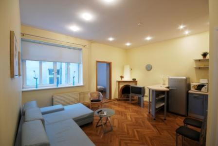 a living room with a couch and a table at Kaunas Apartments in Kaunas