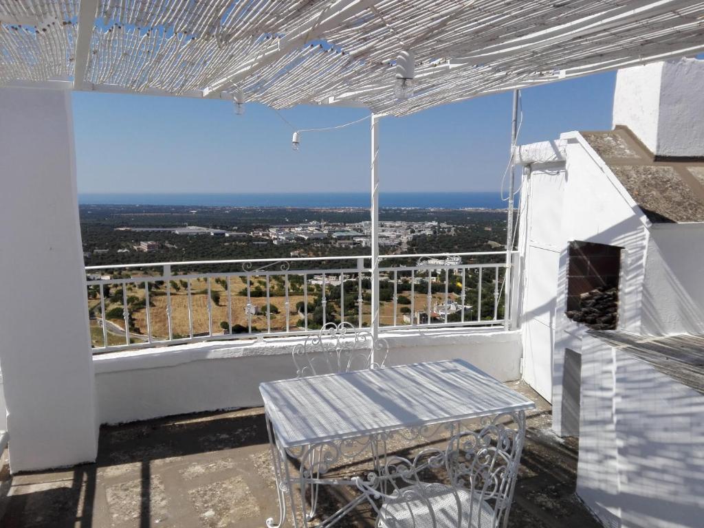 a balcony with a table and a view of the city at Casa La Calce in Ostuni