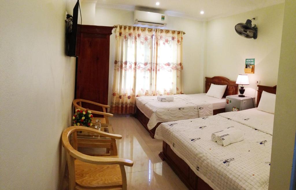 a hotel room with two beds and a window at Ninh Binh Central Hotel in Ninh Binh