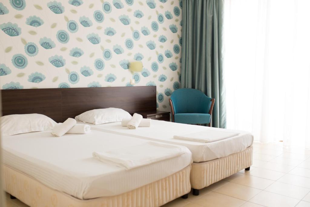 Postel nebo postele na pokoji v ubytování Ema Hotel