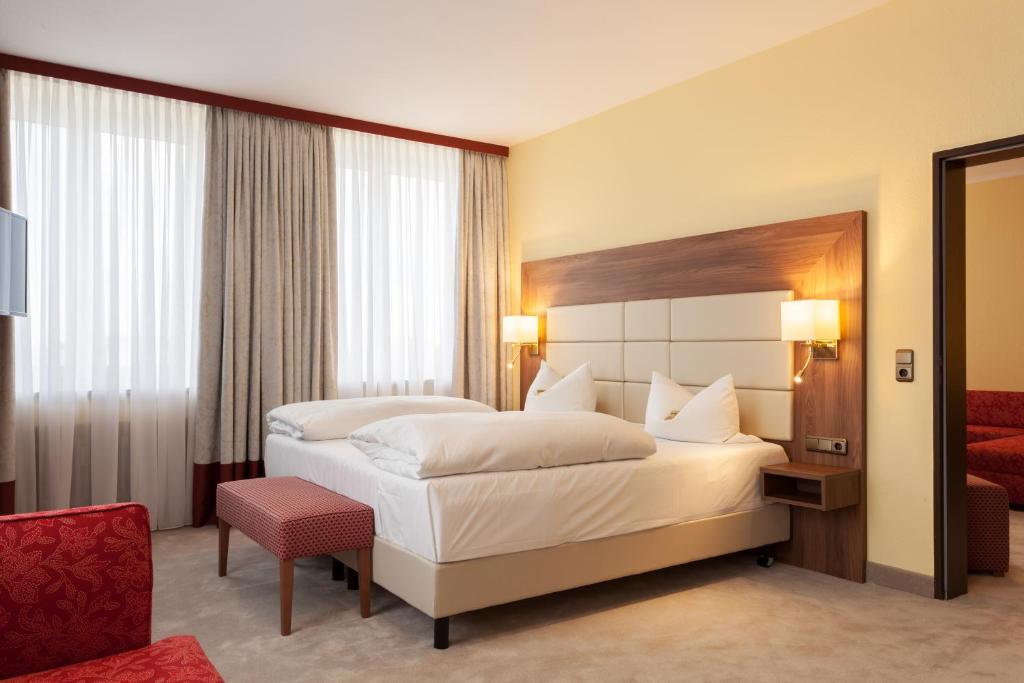 
Ein Bett oder Betten in einem Zimmer der Unterkunft Hotel Augusta
