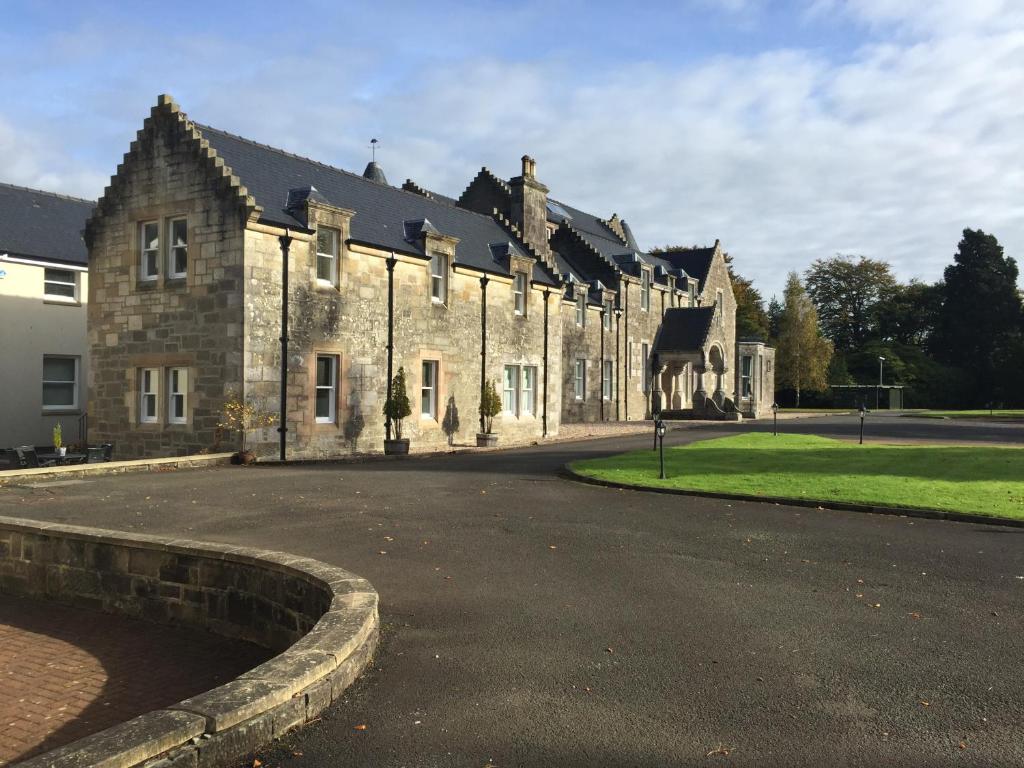 a building with a statue of a giraffe on the side of it at Lomond Castle Apartment in Balloch