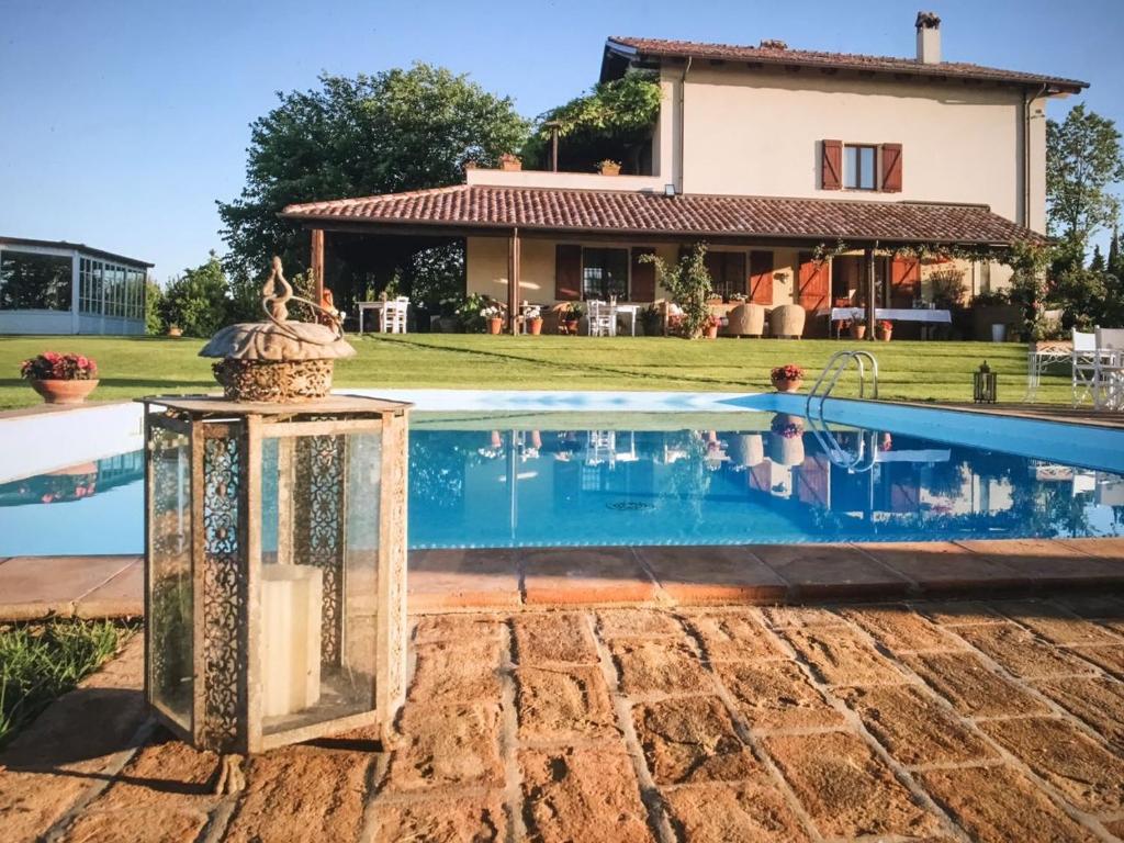 une villa avec une piscine en face d'une maison dans l'établissement Casa Tentoni - Guest House, à Misano Adriatico