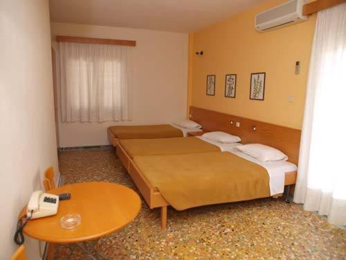 Postel nebo postele na pokoji v ubytování Hotel Markos