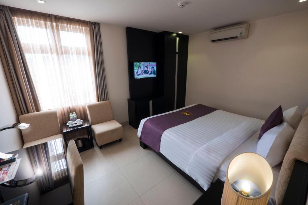 Postel nebo postele na pokoji v ubytování Azumaya Hotel Da Nang
