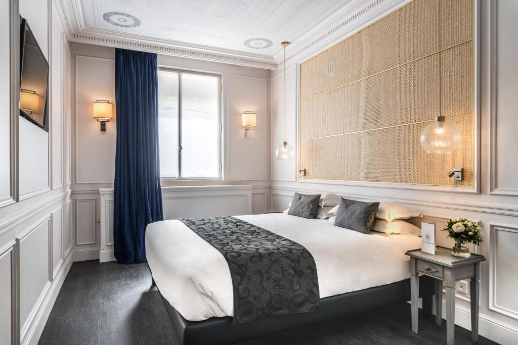 Un ou plusieurs lits dans un hébergement de l'établissement Hôtel Le Versailles