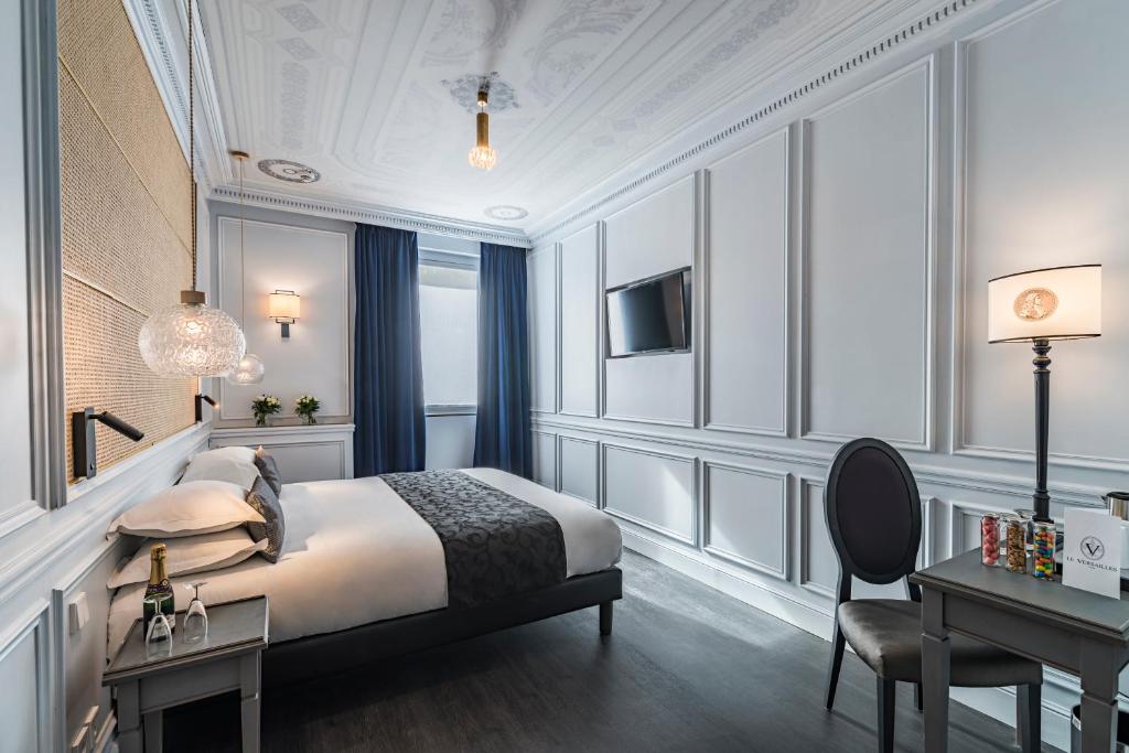 Un ou plusieurs lits dans un hébergement de l'établissement Hôtel Le Versailles