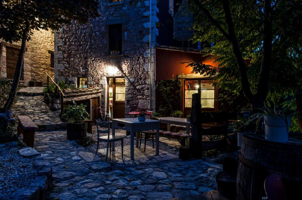 a stone patio in front of a building at night at Agriturismo Slowcanda in Cardella
