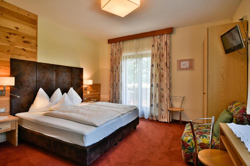 Postel nebo postele na pokoji v ubytování Hotel Villnerhof
