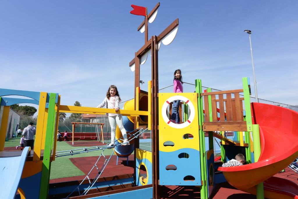 a group of girls playing on a playground at Elite City Resort in Kalamata