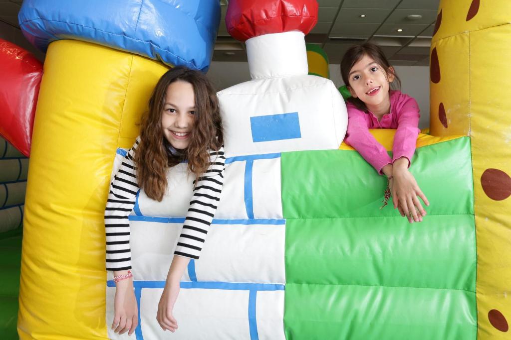 two young girls laying on at Elite City Resort in Kalamata