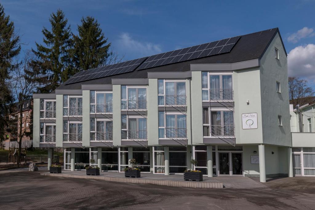 a building with solar panels on top of it at Park Hotel Kelmis in Kelmis