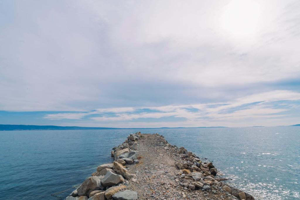 a rocky island in the middle of the water at Apartmani Josip in Podstrana