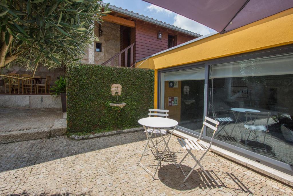 a table and chairs sitting outside of a building at Casa De Santo Andre in Monção