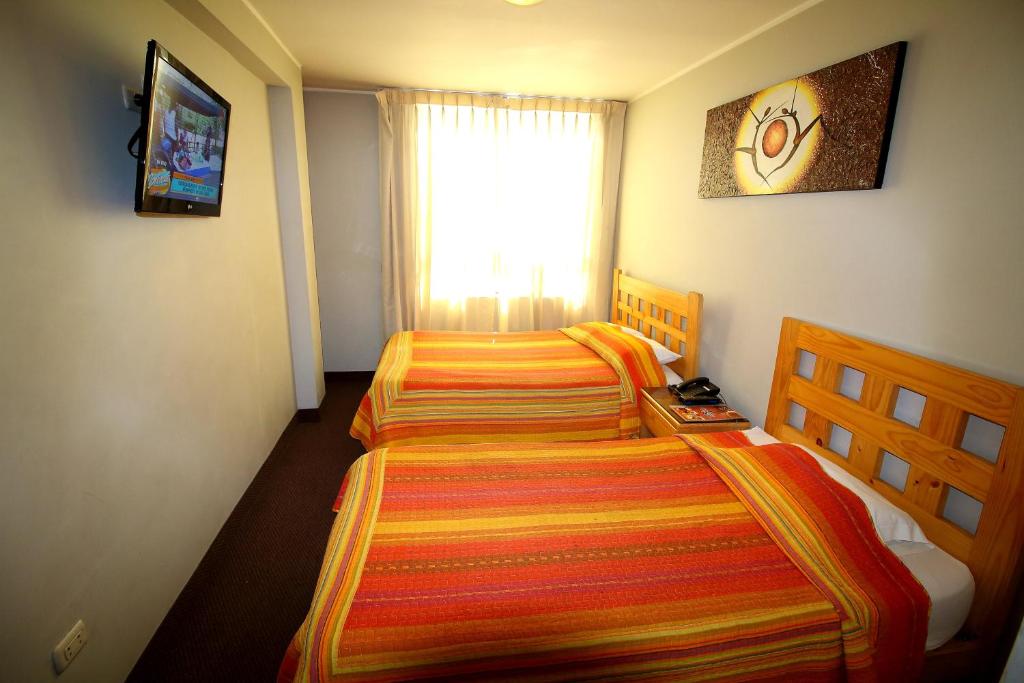 Postel nebo postele na pokoji v ubytování Takora Inn