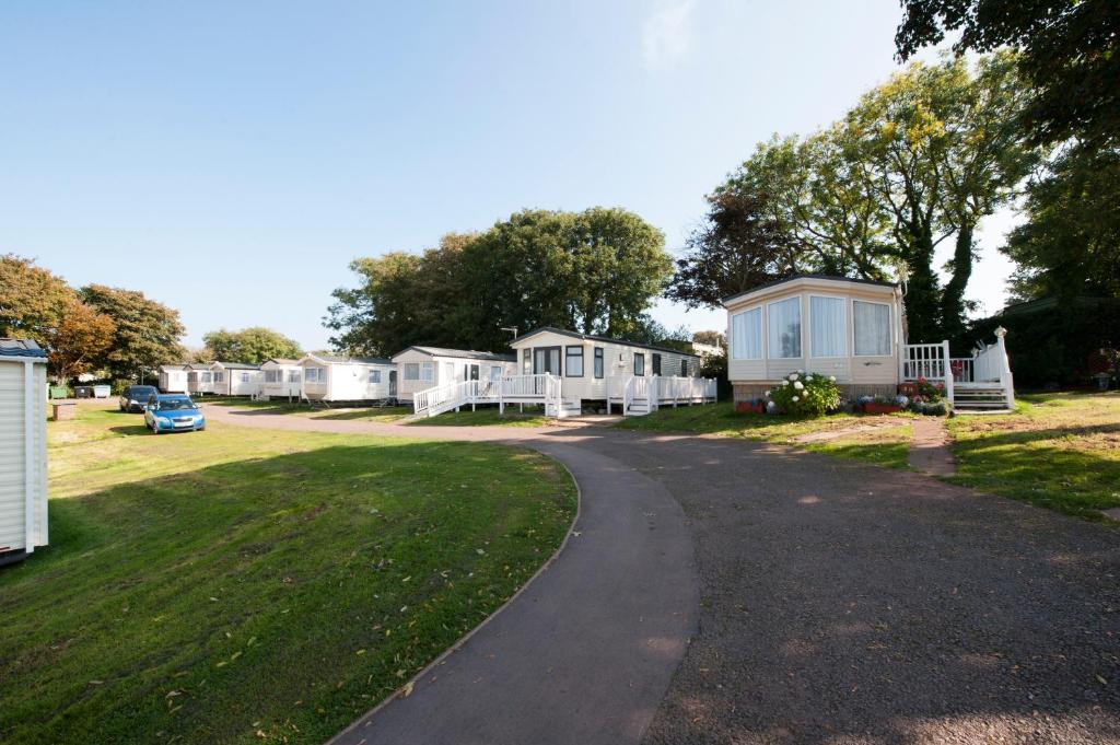 a road leading to a row of mobile homes at South Bay Holiday Park in Brixham