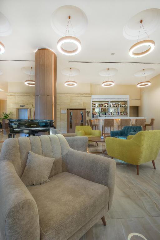 a living room with a couch and a pool table at Vivaldi Hotel in St. Julianʼs