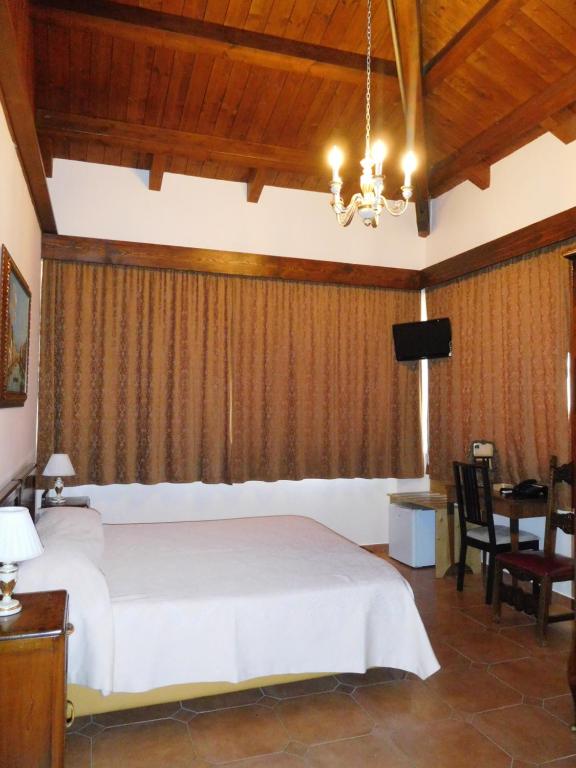 a bedroom with a bed and a table and a television at Hotel Michelangelo in San Bartolomeo in Galdo