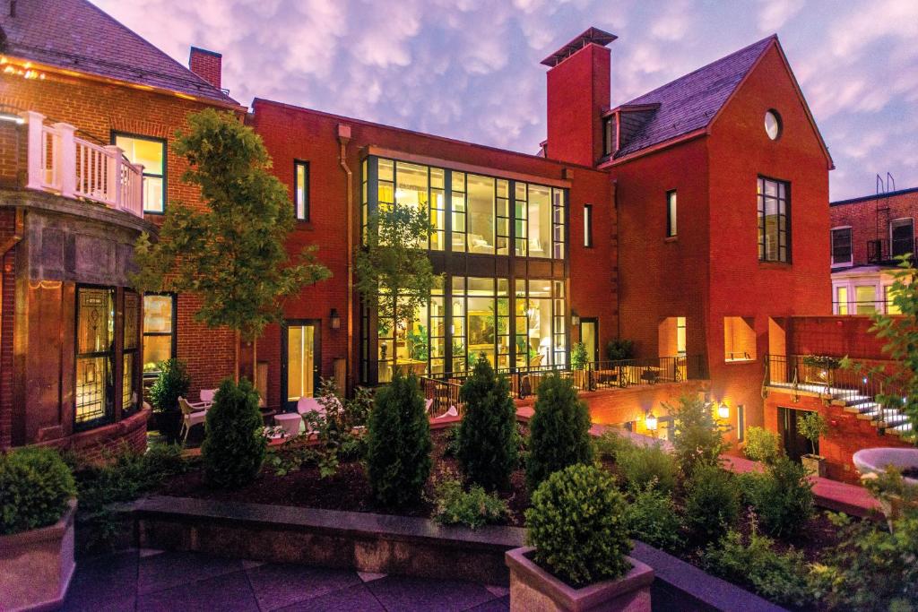 a large red brick building with a courtyard at The Ivy Hotel in Baltimore