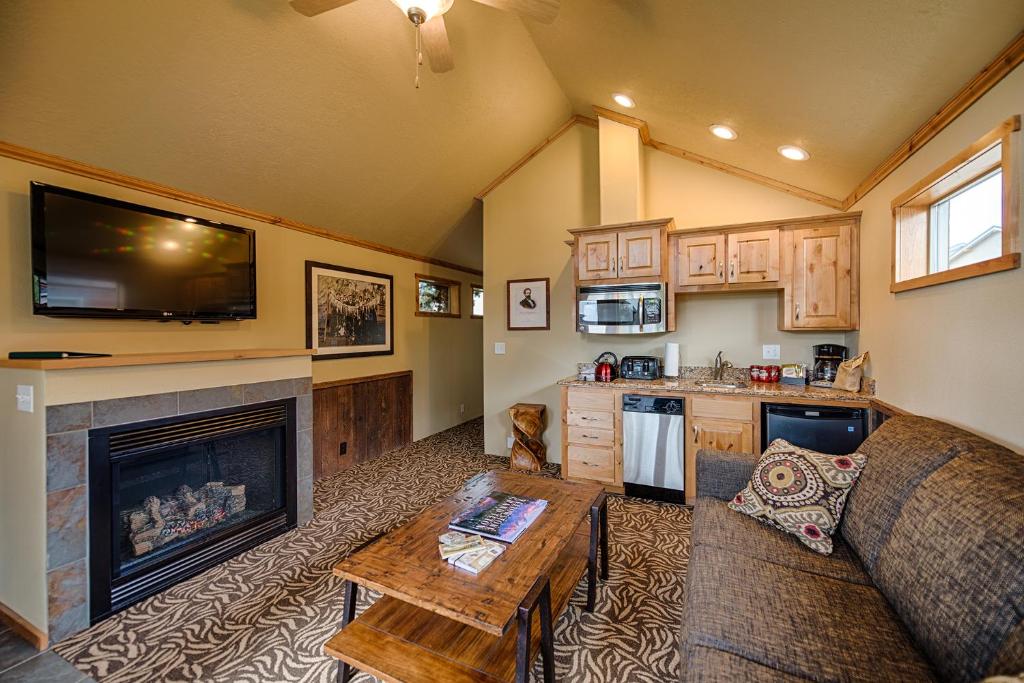 a living room with a couch and a fireplace at Explorer Cabins at Yellowstone in West Yellowstone